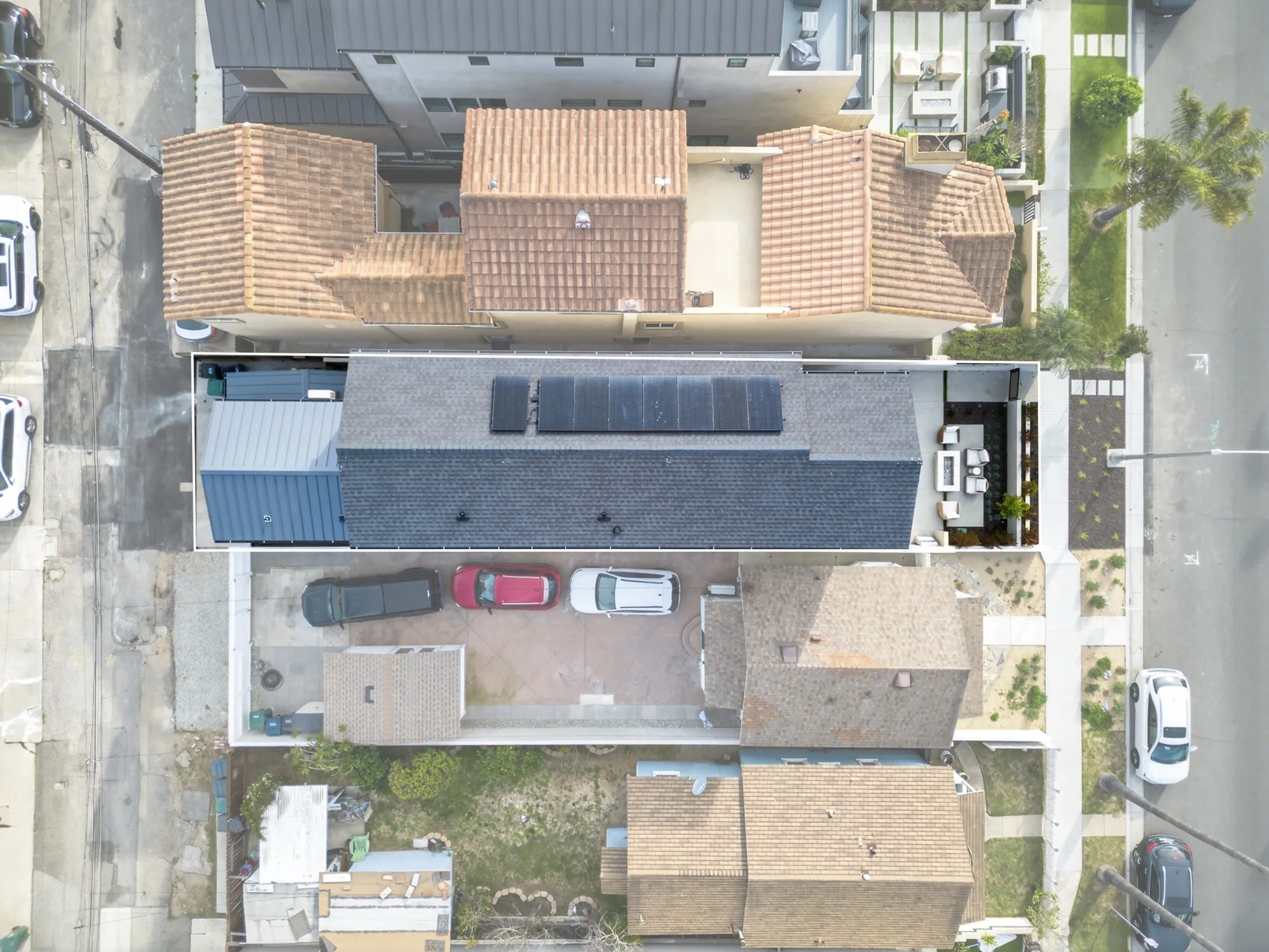Overhead drone photo of modern beach-area home with large solar array