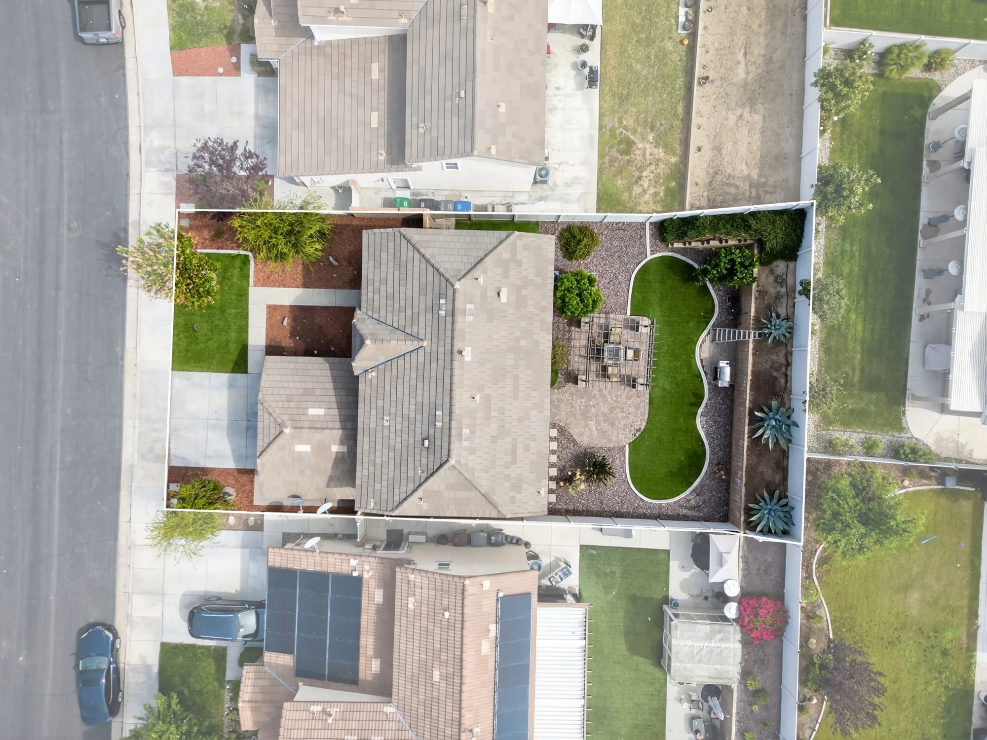 Overhead aerial drone shot of residential property with landscaping