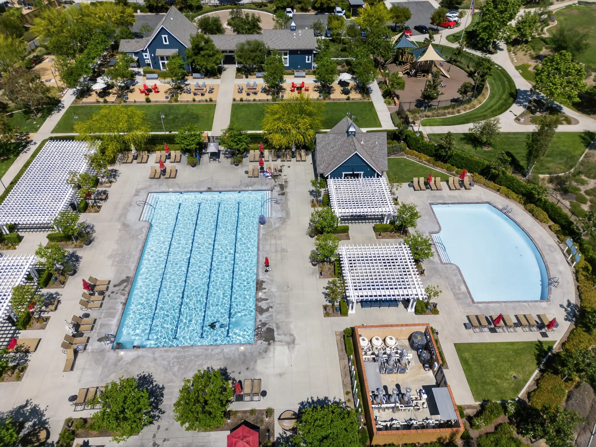 Aerial drone photo of community pool and clubhouse amenity