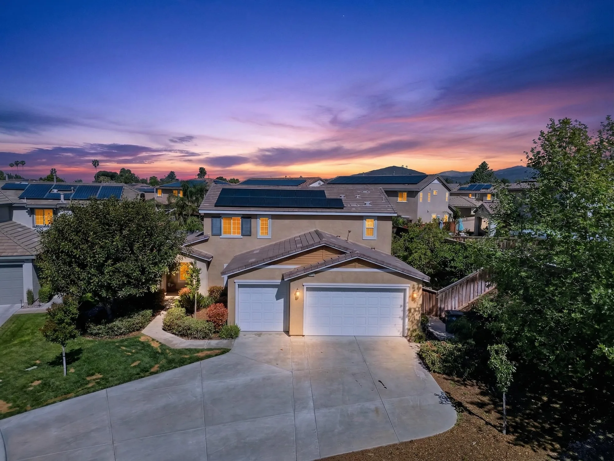 Twilight drone aerial of Inland Empire two-story home at sunset