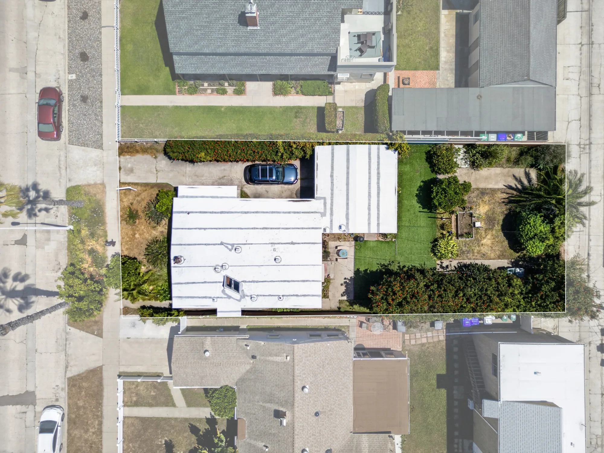 Overhead aerial drone shot of residential property with lot lines and yard
