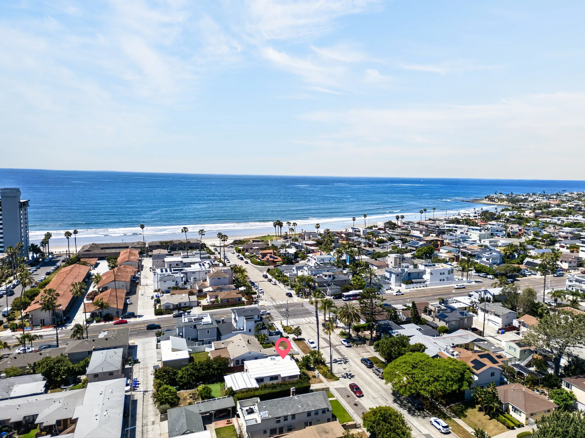 Coastal aerial drone photo of beach home with ocean in background